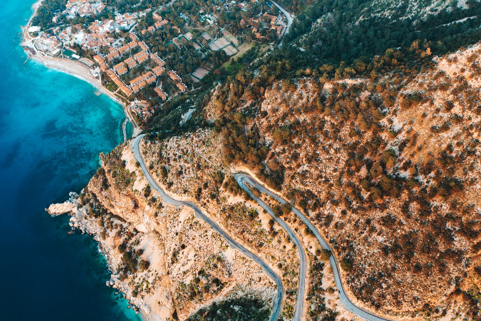 Mountain and winding road at sunset at the sea, drone point of view, Fethiye